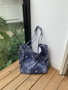 Detail of blue paisley canvas tote bag with large capacity and soft cotton handles