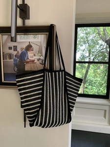 Large woven knit tote bag with black and white stripes and minimalist black shoulder straps