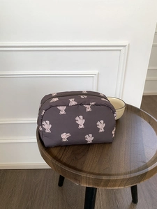 Detail of cute bear pattern on soft quilted makeup bag with zipper closure