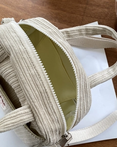 Top view of corduroy crossbody bag showing internal storage space and zipper detail