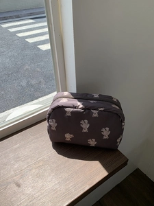 Detail of dark grey cosmetic bag with cute teddy bear prints and smooth top zipper