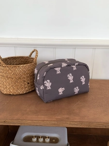 Close-up of a large capacity cosmetic bag with purple bear print and metal zipper closure