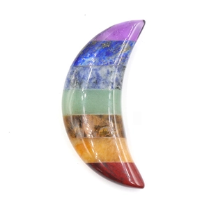 Macro detail of crescent moon seven chakra healing stone with polished layered crystals