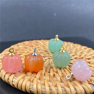 Dettaglio macro di ciondoli a forma di zucca in quarzo rosa e avventurina con ganci