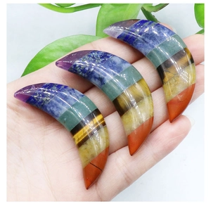 Three crescent moon-shaped polished chakra crystals with colorful gemstone layering