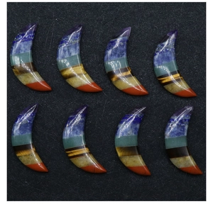 Macro view of moon-shaped seven chakra stones showing layered natural crystal textures