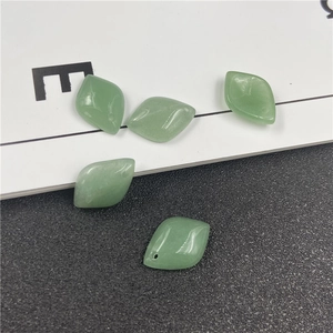 Macro shot of five diamond-shaped green aventurine stone beads for DIY jewelry making