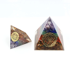 Detailed comparison of two handmade resin pyramids with natural seven-chakra crystals