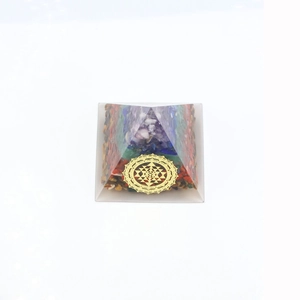 Macro view of Orgonite Pyramid featuring seven chakra natural stones and Sri Yantra symbol