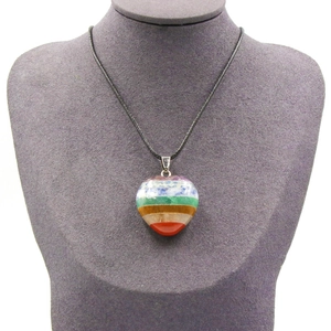 Chakra healing heart pendant with seven layered natural stones on black woven cord