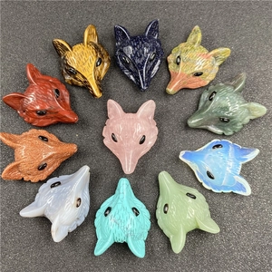Detailed view of hand-carved fox head pendants in eleven types of colorful semi-precious stones