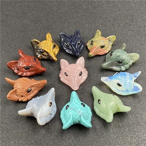 Macro shot of assorted carved fox head pendants made of natural crystal and tiger eye stones