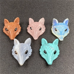 Detailed view of five gemstone fox head charms including rose quartz and tiger eye