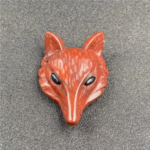 Detailed view of hand-carved red jasper fox head pendant with inlaid black bead eyes