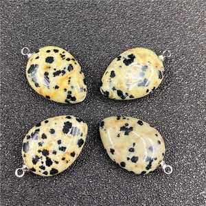 Detail of four teardrop Dalmatian Jasper pendants with polished silver metal bails