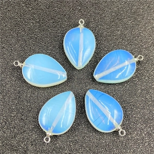 Set of five blue leaf-shaped opal pendants with silver loops on grey texture