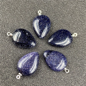 Macro shot of five teardrop blue sandstone pendants with shimmering starry effects