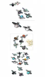 Macro detail of bee pendant brooch with abalone shell wings and mixed gemstones