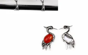 Detailed view of vintage crane brooch showing red agate inlay and secure pin clasp