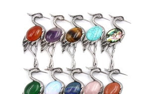 Detailed collection of vintage crane brooches featuring ten colorful inlaid gemstones