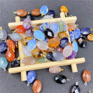 Polished oval gemstone pendants with metal bails in various colors and stone materials