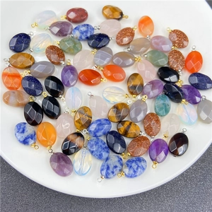 Macro shot of assorted faceted oval gemstone pendants with metal hooks for DIY jewelry