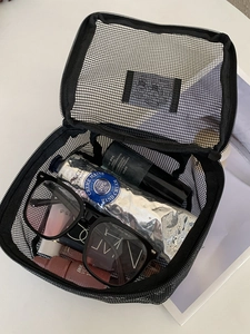 Portable black mesh travel makeup bag with large capacity for toiletries and cosmetic storage
