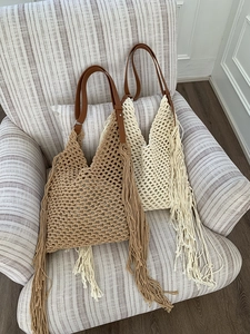 Detailed knit pattern on khaki and cream woven tote bags with leather handles and long tassels