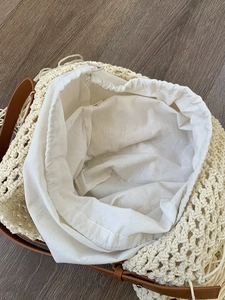 Bohemian style hollow woven tote bag with drawstring inner pouch and leather straps