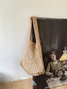 Detail of handmade woven tote bag with hollow diamond mesh and cotton inner lining