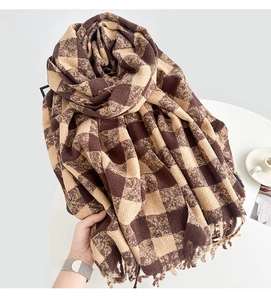 Detail of brown and beige checkered scarf with soft texture and fringed edges