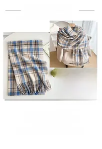 Detailed close-up of blue and brown plaid scarf with tassels and winter styling