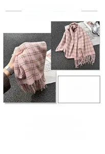 Close-up of pink plaid tassel scarf with soft cashmere-like texture and fringed edges