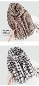 Detailed close-up of plaid imitation cashmere scarf featuring fringe edges and soft texture