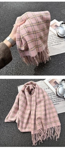 Close-up of pink and yellow plaid scarf with fringe tassels and soft cashmere-like texture