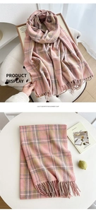 Detailed texture of lilac plaid cashmere scarf featuring soft fringe and warm woven fabric