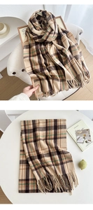 Detail of brown plaid scarf with long fringe and soft texture for autumn and winter