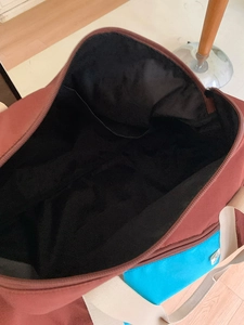 Brown and blue nylon tote bag showing spacious internal structure with side pocket