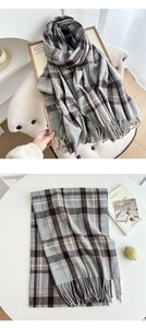 Close-up of grey and brown plaid scarf with soft fringe details and thick texture