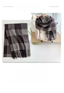 Close-up of thick winter scarf with dark brown plaid pattern and fringe detail