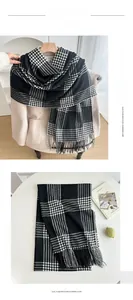 Close-up of black and white plaid scarf with tassels made of soft imitation cashmere