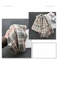 Close-up of soft plaid scarf in green and beige with tassel edges near magazine