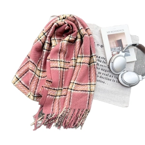 Pink checkered plaid scarf with soft tassels in a stylish flat lay lifestyle setting