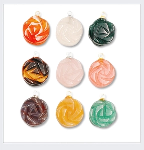 Detail showing nine colorful carved agate rose pendants with metal bail attachments