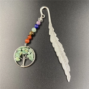 Detail of silver feather bookmark with colorful chakra beads and tree of life pendant