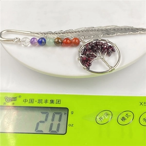 Detailed view of Tree of Life feather bookmark on a digital scale weighing exactly 20g
