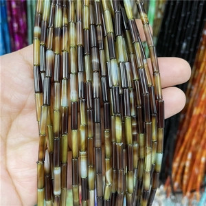 Close-up of polished 3x12mm cylindrical agate beads showing natural banded textures