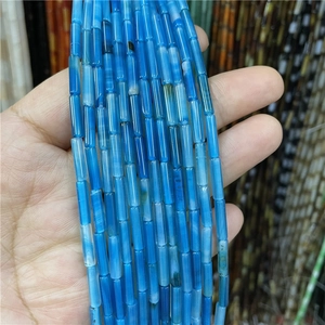 Macro shot of 3x12mm blue agate cylinder beads showing natural texture and finish