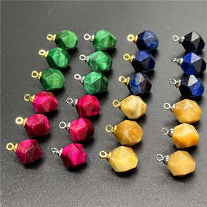 Macro detail of multifaceted tiger eye stone pendants with gold and silver connectors