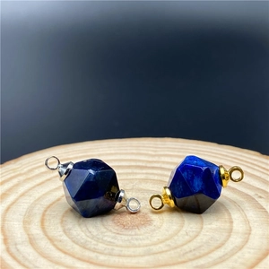 Macro detail of faceted tiger eye stone connectors with gold and silver loops for jewelry DIY